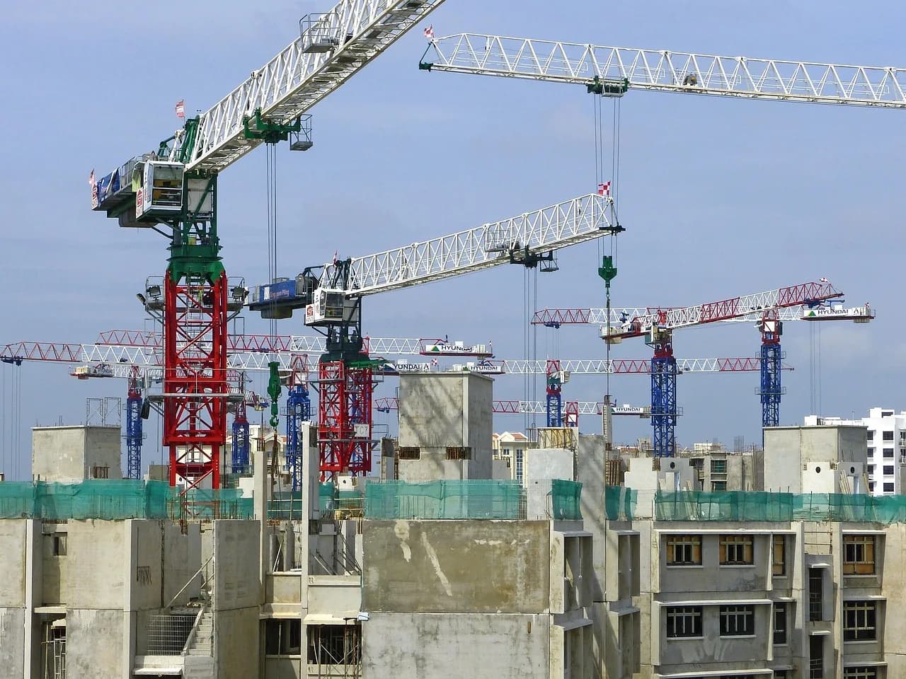 Commercial development site with crane and blue sky